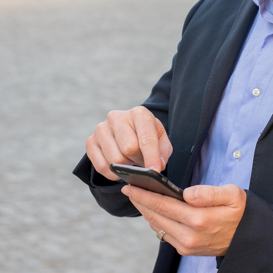 photograph of hands holding a smartphone